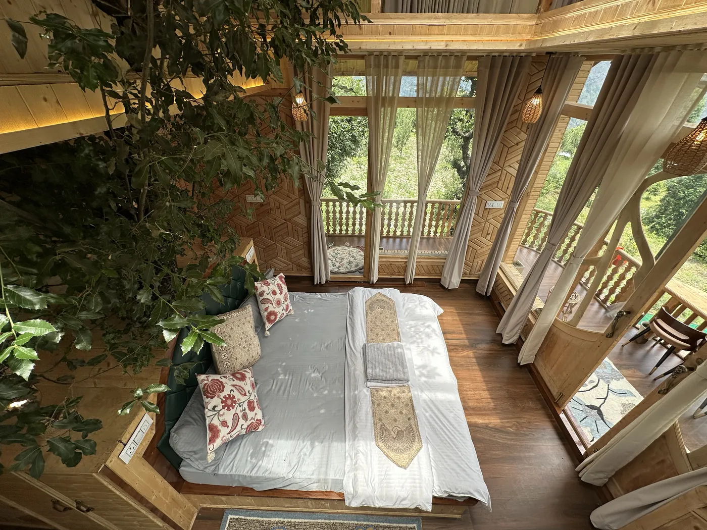 Bed seen from the loft with a sheepskin rug and the deck below