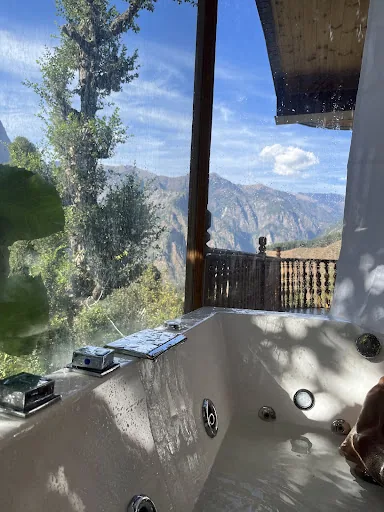 The bathroom: a private jacuzzi beside a window that looks onto the mountains