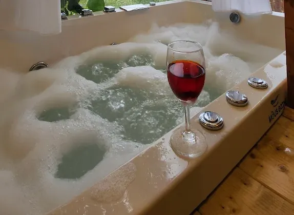 Bubbling private jacuzzi beside the window of the Deluxe Room
