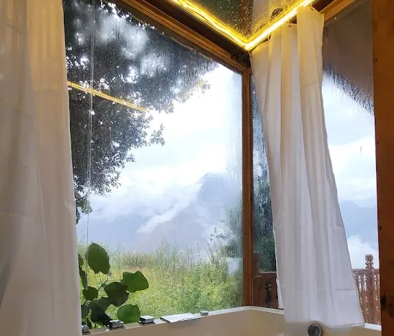 Looking out from the jacuzzi to clouds and mountains